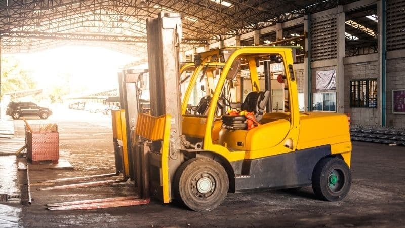 A fleet of manual forklifts in a warehouse