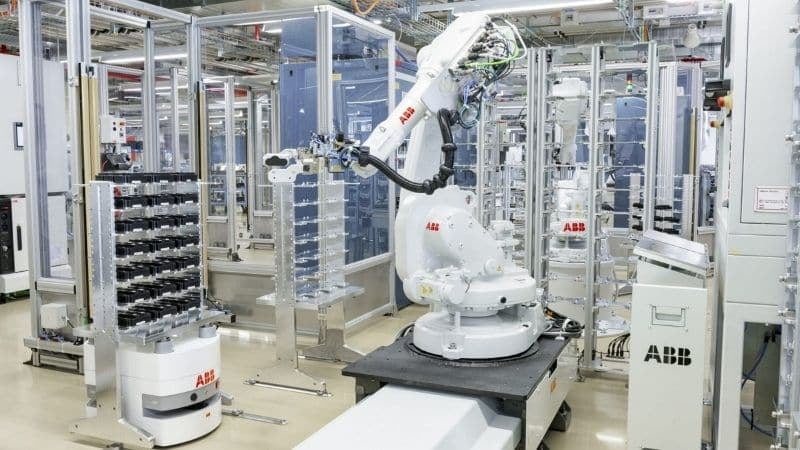 An ANT driven mini AGV (left) transfers components to an IRB 1600 robotic arm.