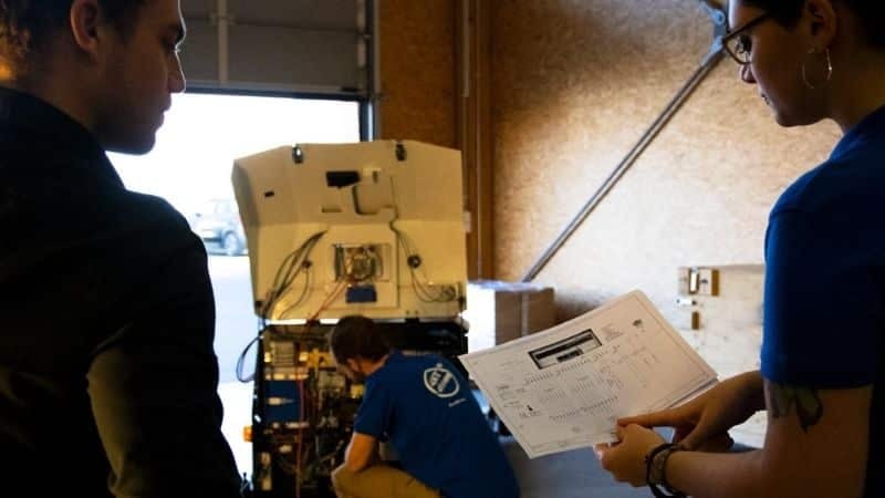 Engineers working on an AGV in an industrial environment