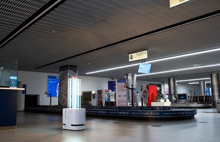 Mini UVC robot disinfects an airport luggage carousel.